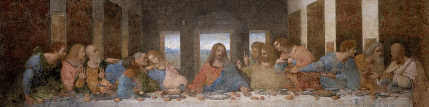 Jesus sits calmly at the centre of a long table as the twelve apostles lean together and gesture around him